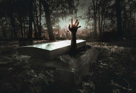 Hand rising out from the graveの写真素材