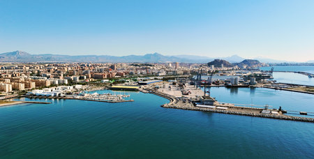 Aerial view of marina filled with numerous docked boats in the clear turquoise water of Mediterranean Sea and urban landscape of Alicante town, Spain. Costa Blancaの写真素材