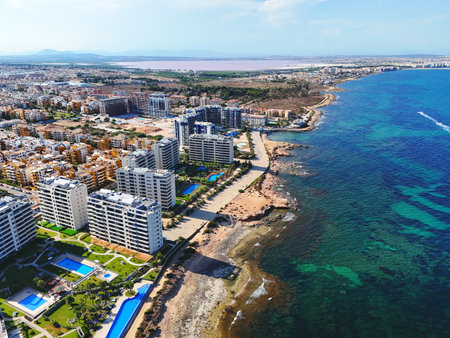 Aerial view of Punta Prima coastline with modern high-rise residential building. Costa Blanca, Alicante province. Spainの写真素材