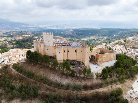 Stunning drone view of Castillo de Velez-Blanco Renaissance castle perched on rocky hill in Andalusia, Spain, surrounded by rolling hills. Medieval and Moorish heritage conceptの写真素材