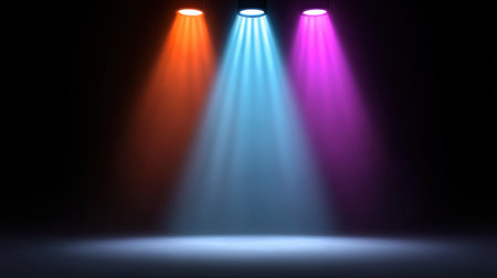 This striking image showcases vibrant stage lights in orange, blue, and pink, creating a dramatic spotlight effect against a dark background, perfect for theatrical themes.の素材
