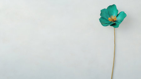 A stunning teal flower stands tall against a soft background, perfect for minimalist themes. This image highlights the intricate beauty of nature in a simple, elegant way.の素材