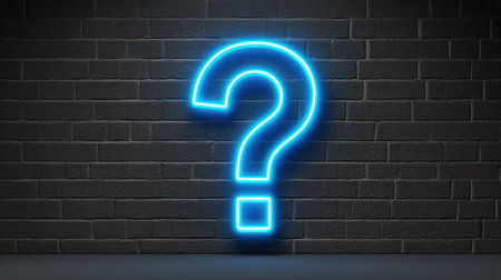 A vibrant neon blue question mark glows against a dark brick wall, representing curiosity and inquiry in a modern artistic context. Perfect for creative projects.の素材