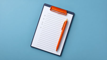 A clean and minimalist checklist displayed on a clipboard with an orange pen on a blue background, ideal for illustrating task management and organization.の素材