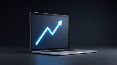 A modern laptop displays a graph indicating a positive trend on its screen, set against a dark background. This image encapsulates themes of growth, finance, and technology, making it ideal for business-related media or presentations.の素材