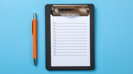 A clipboard with a blank checklist and an orange pen rests on a bright blue background, ideal for organizational tasks and planning activities.の素材