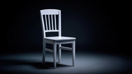 This image features a striking white chair set against a dark background, highlighting minimalist design elements and showcasing simplicity in modern furniture.の素材