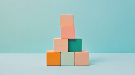 A vibrant arrangement of colorful wooden blocks stacked playfully against a soft blue background, ideal for educational themes, design ideas for children's spaces or creative projects.の素材