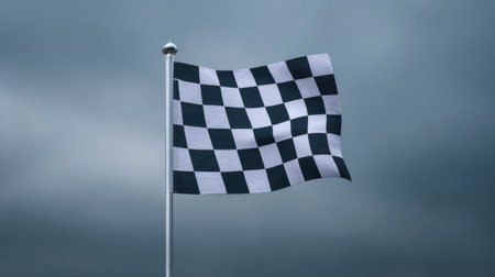 A black and white checkered flag flutters in the wind, set against a dramatic dark sky, symbolizing victory and competition in various racing sports.の素材