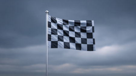 A striking image of a black and white checkered flag fluttering in the wind, set against a dramatic cloudy sky, symbolizing competition and victory.の素材