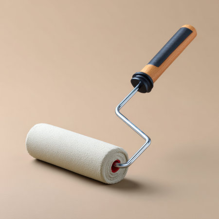 A paint roller is positioned on a simple background, showcasing its wooden handle and fabric roller for painting walls. Ideal for home improvement.の素材