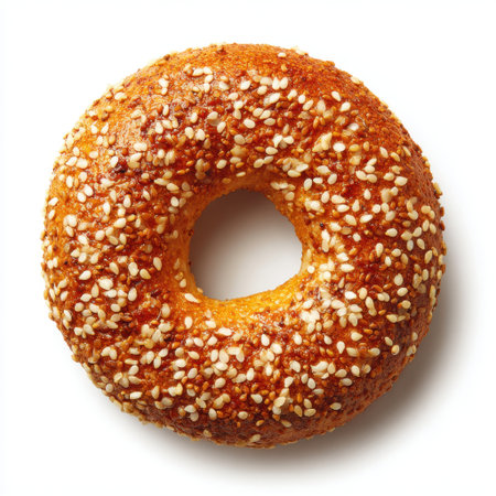This image features a freshly baked sesame bagel with a golden brown crust and soft inside, perfect for breakfast or a snack. The bagel showcases a rich texture and delicious aroma, making it an ideal choice for food enthusiasts.の素材