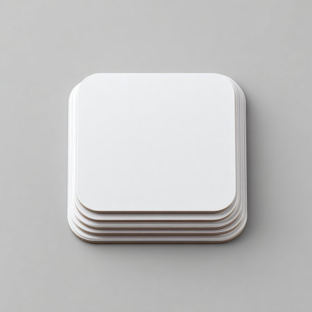 A minimalist stack of blank coasters arranged on a smooth surface showcases a clean and modern aesthetic, perfect for design projects and mockups.の素材