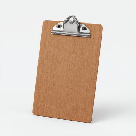 This image features a wooden clipboard with a sturdy metal clip set against a clean white background. Perfect for showcasing stationery, note-taking, or organizational tasks.の素材