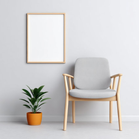 A modern minimalist interior featuring a stylish chair and a vibrant green plant in an orange pot, with an empty wooden frame on the wall, ideal for cozy spaces.の素材