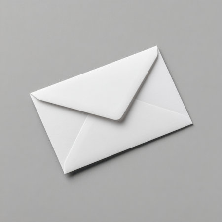This image features a simple white envelope placed on a smooth gray background, perfect for themes related to communication, letters, and minimalistic design.の素材