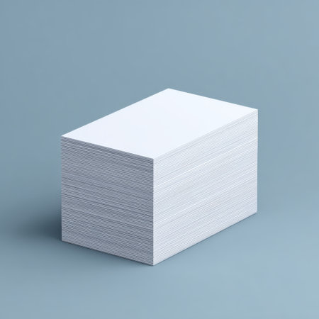 A stack of blank white business cards positioned on a light blue background, ideal for use in branding, marketing materials, and professional presentations.の素材