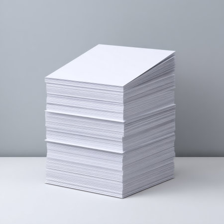 A neat stack of blank sheets of paper rests on a clean surface against a soft gray background, perfect for office use, presentations, or creative projects.の素材