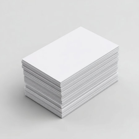 A blank stack of white business cards placed neatly on a light surface, ideal for creating personalized designs or printing unique branding materials.の素材