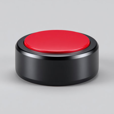 A bright red round button set on a smooth gray background, perfect for illustrating digital interaction and control concepts in design projects.の素材