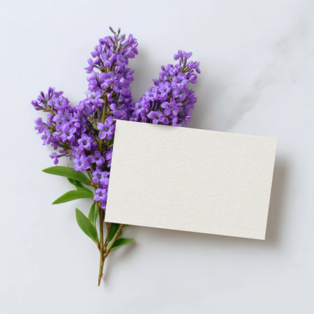 A stunning arrangement of vibrant purple flowers paired with a blank card, perfect for creating personalized messages, invitations, or artistic projects.の素材