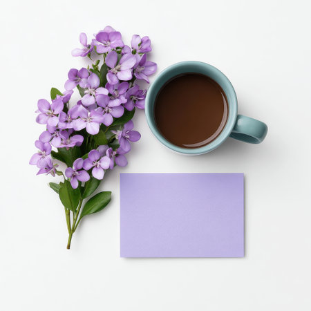 A serene composition showcasing fresh purple flowers, a steaming coffee mug, and a blank card on a white background, perfect for thoughtful greetings.の素材
