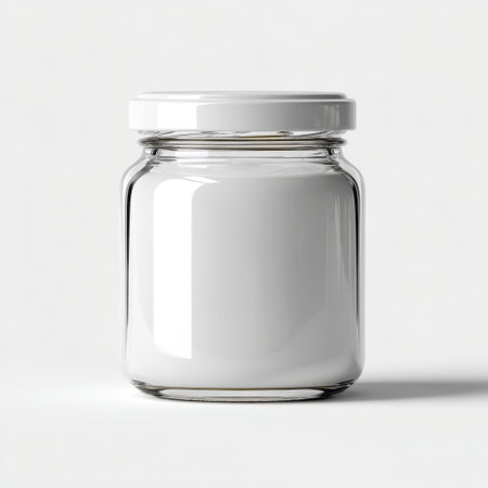 A clean, empty glass jar with a white lid sitting on a light backdrop, ideal for showcasing products, branding ideas, or packaging designs in presentations.の素材