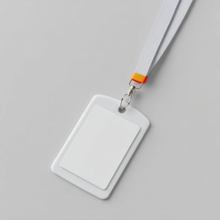 A blank identification badge attached to a lanyard, ideal for events or professional settings. Perfect for easy customization and essential for security and access control.の素材
