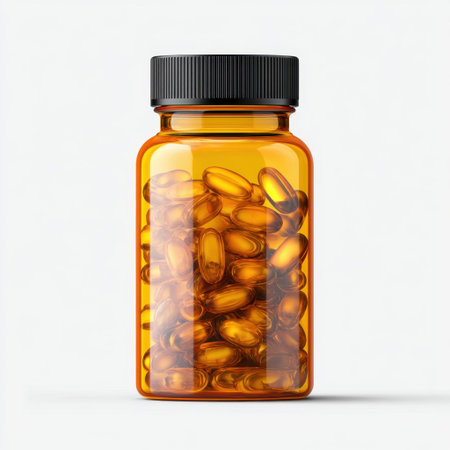 A clear orange bottle filled with golden gel capsules, ideal for health and wellness visuals. Perfect for supplement and pharmaceutical applications.の素材