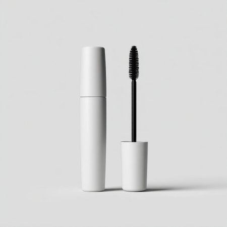 This minimalist image features a white mascara tube with a brush, set against a neutral background. Ideal for beauty and cosmetics branding.の素材