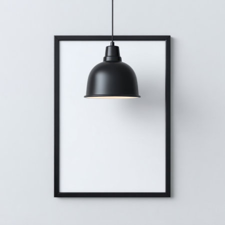 This striking image showcases a black pendant light suspended within a minimalist frame against a soft gray wall, creating a serene and modern ambiance.の素材