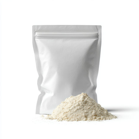 This image features a sealed pouch of white flour next to a mound of flour on a clean white background, ideal for culinary and baking projects.の素材