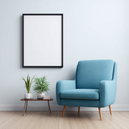 This image showcases a cozy living room corner featuring a stylish blue armchair, a small table, and a plant, perfect for relaxation and design inspiration.の素材