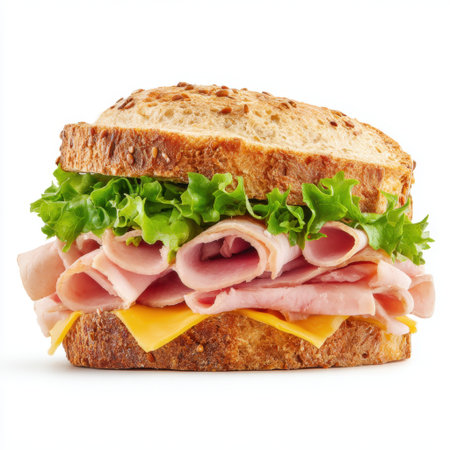 A delicious sandwich featuring fresh layers of ham, melted cheese, and crisp lettuce on whole grain bread, perfect for a hearty meal or snack option.の素材