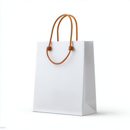 A simple and elegant empty white shopping bag with orange handles, ideal for showcasing products in retail settings or for marketing campaigns.の素材
