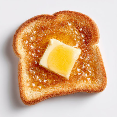 A beautifully toasted slice of bread topped with a pat of butter and a drizzle of honey, showcasing simple yet delicious breakfast options. Perfect for food lovers.の素材
