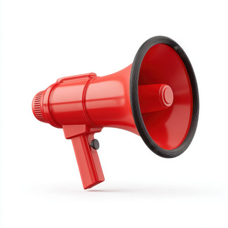 A bright red megaphone stands prominently against a white background, symbolizing communication and the power of voice for events, announcements, and public speaking.の素材