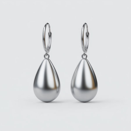 This image features elegant silver drop earrings with a polished surface, ideal for enhancing any outfit. Perfect for gifting or personal use, these stylish accessories embody modern sophistication and minimal design principles.の素材