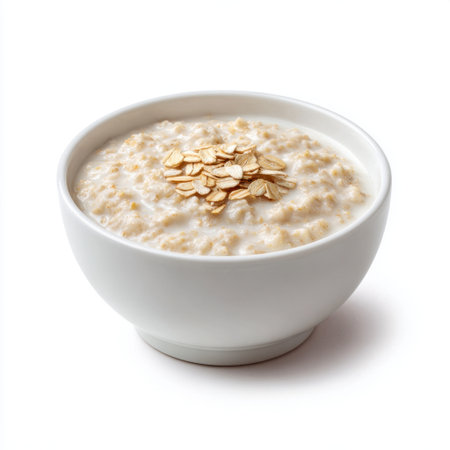 A warm bowl of creamy oatmeal topped with rolled oats and granola, perfect for a nutritious breakfast or snack. A simple meal for healthy living.の素材