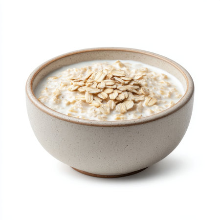 A close-up view of a bowl of creamy oatmeal topped with oats, perfect for a hearty breakfast or healthy snack. Ideal for nutrition-focused recipes.の素材