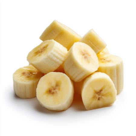 This image showcases a pile of freshly sliced bananas arranged neatly against a clean white background. Ideal for promoting healthy eating, recipes, or fresh produce.の素材