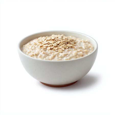 A simple yet enticing bowl of creamy oatmeal is topped with a sprinkle of oats, showcasing healthy breakfast options in a clean, minimalistic style.の素材