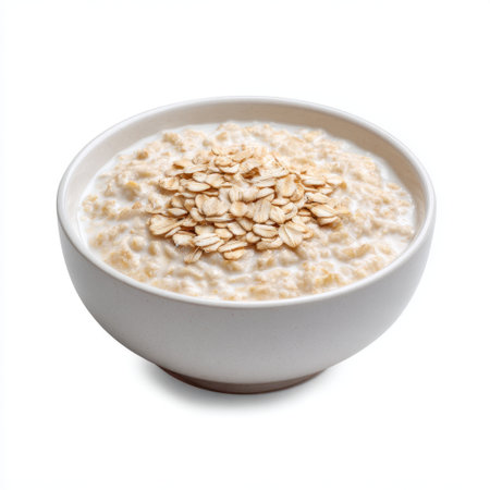 This image features a bowl of fresh oatmeal garnished with oats, set against a clean white background, perfect for highlighting nutritious breakfast options.の素材