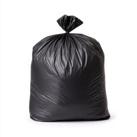 A large black garbage bag brimming with waste, ideal for municipal recycling and disposal efforts. Perfect for showcasing cleanliness in household environments.の素材