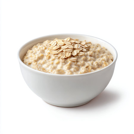 A close-up view of a bowl filled with warm and creamy oatmeal topped with rolled oats, perfect for a nutritious and healthy breakfast option.の素材