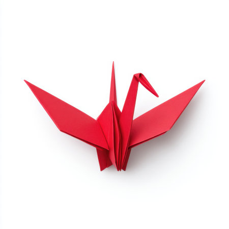 This image features a stunning red origami crane, symbolizing peace and hope, displayed in an artistic manner against a clean white background.の素材