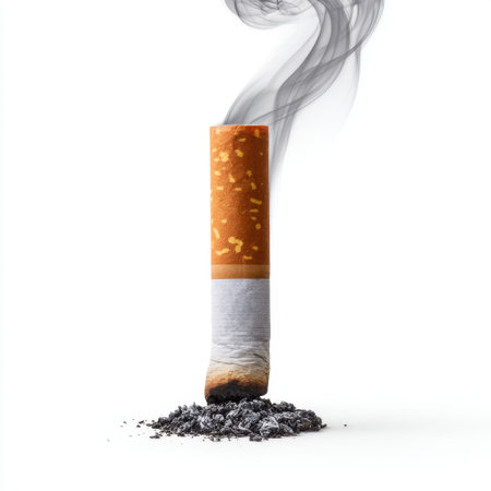This striking image captures a cigarette butt resting in ashes, with soft smoke swirling above, highlighting the health risks and social issues associated with smoking.の素材