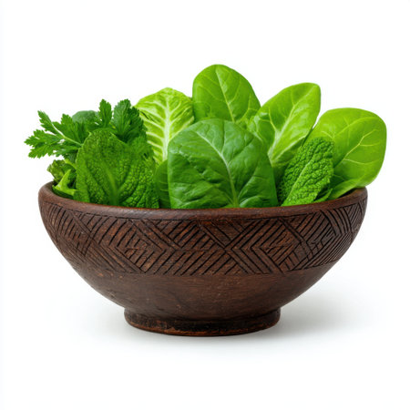 A rustic wooden bowl filled with an assortment of fresh green leafy vegetables showcases nature's bounty, perfect for healthy cooking and meal preparation.の素材