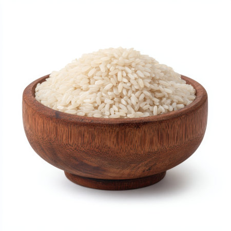 This image features a generous portion of fresh white rice in a rustic wooden bowl, perfect for culinary and food-related projects. The simplicity and purity of the rice make it ideal for various uses, from recipes to dietary illustrations.の素材