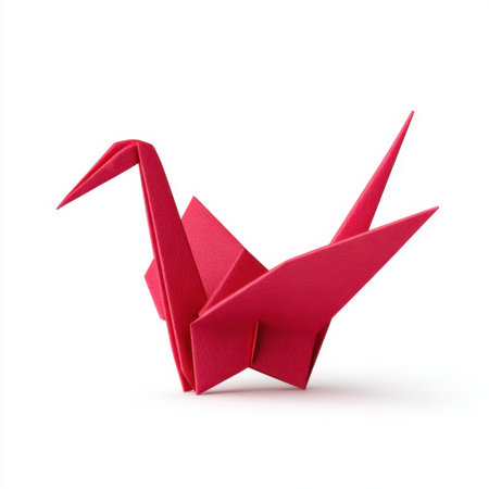 This striking red origami crane sculpture stands elegantly against a clean white background, showcasing artistry in paper folding and cultural significance.の素材